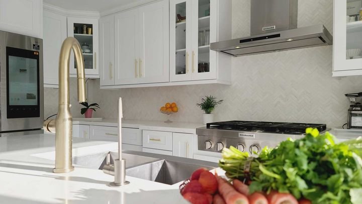 Island with a gold faucet, Canada Kitchens cabinets