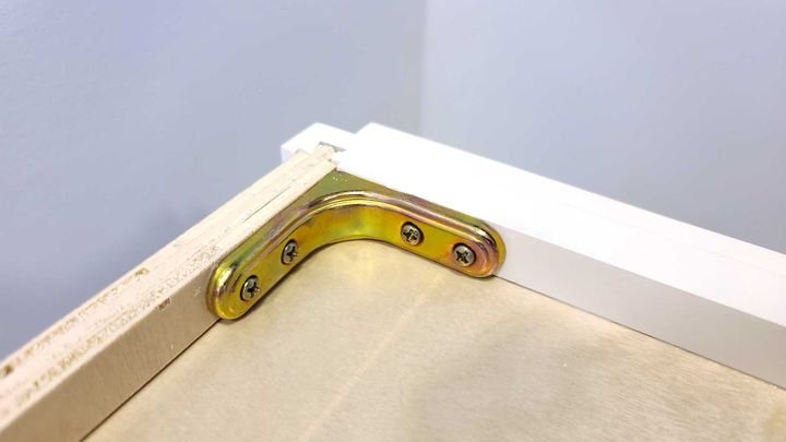 Metal corner bracket inside a cabinet box in a Canada Kitchens cabinet