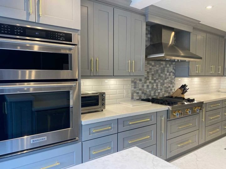 Gold handles and wall ovens, Shaker Grey cabinets by Canada Kitchens