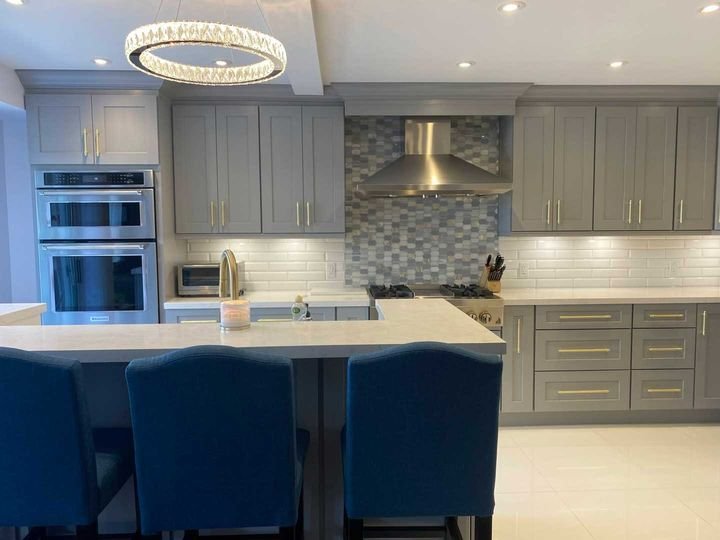 Island with blue bar stools, Shaker Grey cabinets by Canada Kitchens