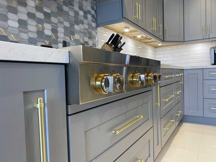 Range close-up with brass pulls, Shaker Grey cabinets by Canada Kitchens