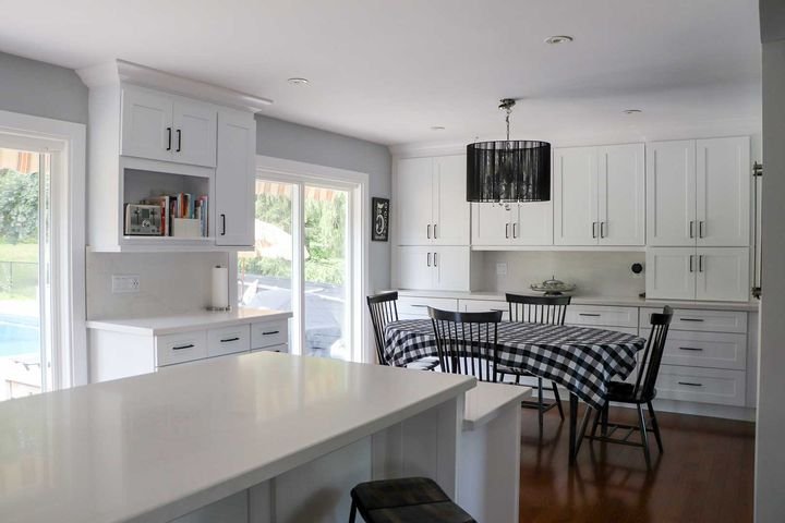Kitchen with a backyard view, Shaker White cabinets by Canada Kitchens