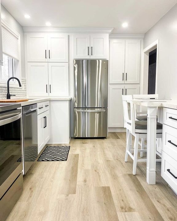 Fridge wall with tall panels, Shaker White cabinets by Canada Kitchens
