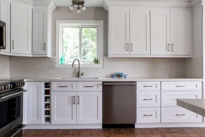 Sink under a window, Shaker White cabinets by Canada Kitchens