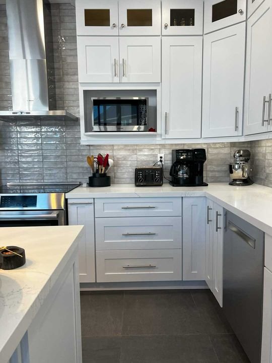 Built-in microwave cabinet and range wall, Shaker White cabinets by Canada Kitchens