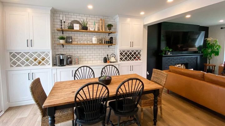 Wine racks beside a dining table, Shaker White cabinets by Canada Kitchens