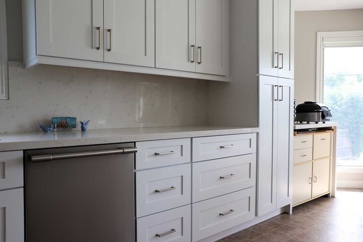 Sink run and tall pantry, Shaker White cabinets by Canada Kitchens