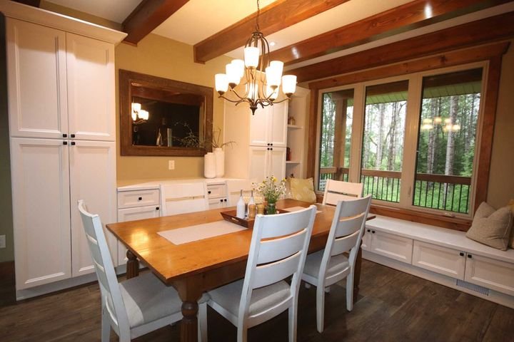Kitchen with a dining table, York White cabinets by Canada Kitchens