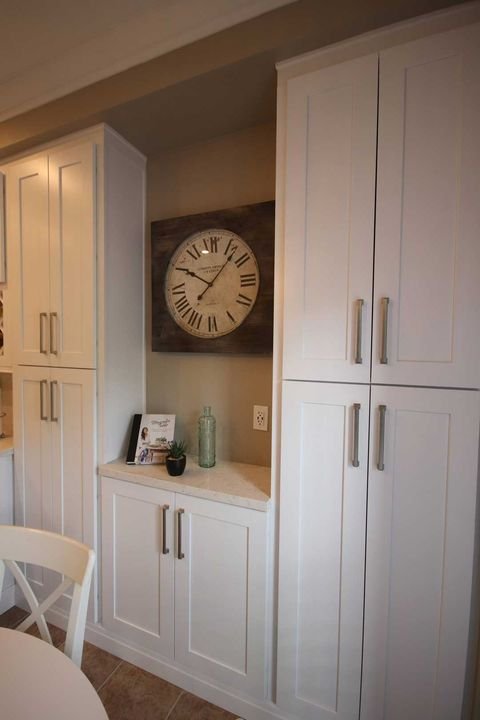 Pantries with a wall clock, York White cabinets by Canada Kitchens