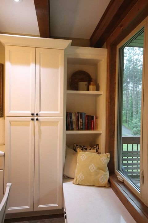 Pantry with an open bookshelf end, York White cabinets by Canada Kitchens