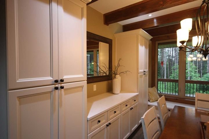 Tall pantry beside a dining area, York White cabinets by Canada Kitchens